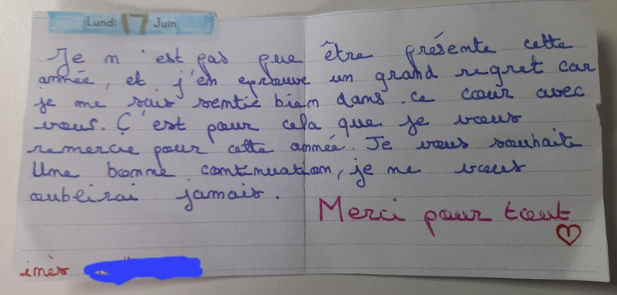 A young child curiously holding a small violin.